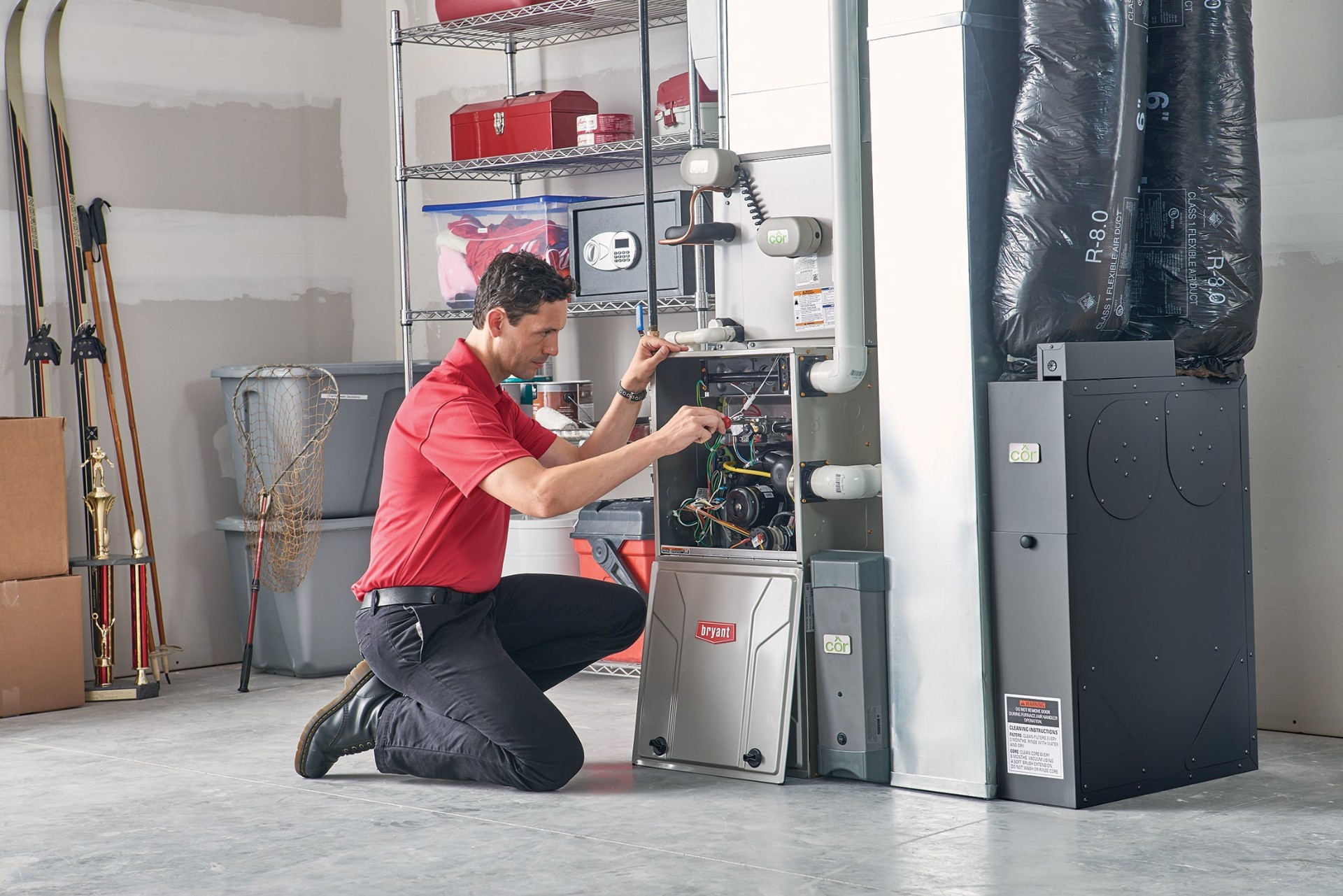HVAC technician inspecting a residential gas furnace in an Ontario basement during winter