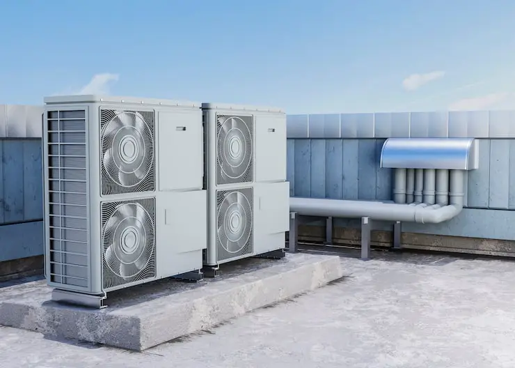 Modern dual-fan HVAC units on a bright commercial rooftop.