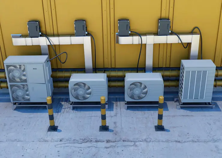 Multiple outdoor HVAC or heat pump compressor units mounted on a building.